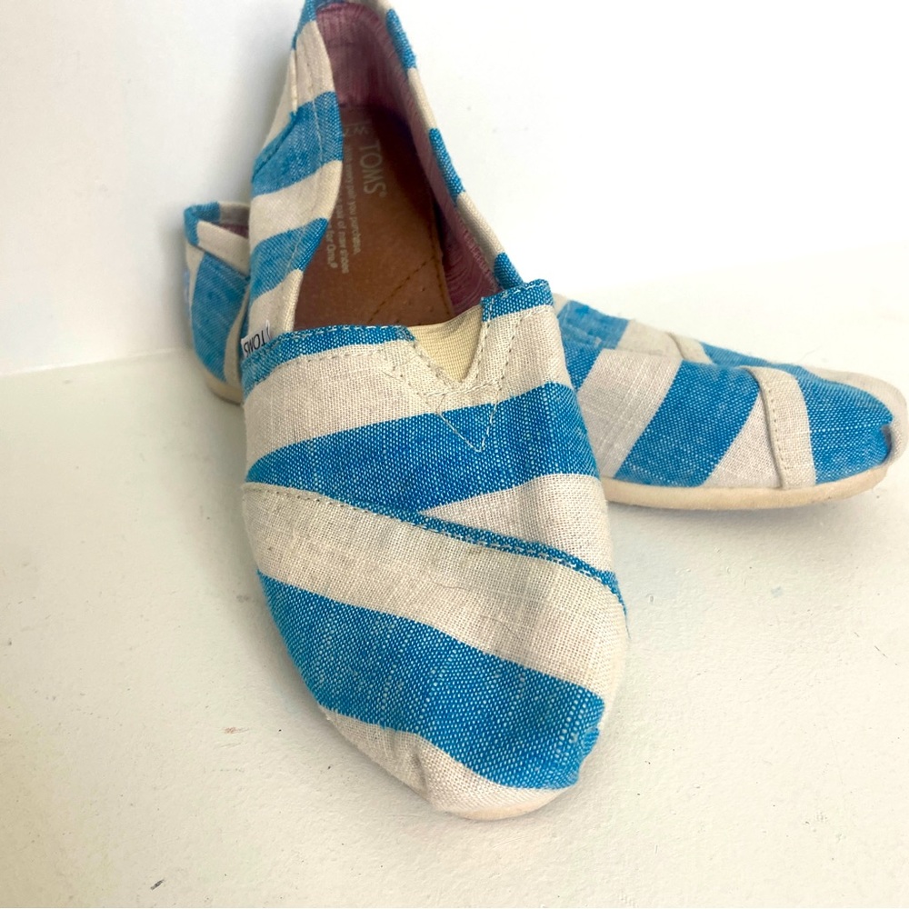 Women’s TOMS blue and white slip-on shoes.